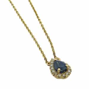 Lady's 14K yellow gold necklace, set with 0.603 carat pear shape Alexandrite and accented with fifteen round brilliant cut diamonds totaling 0.11 carats.