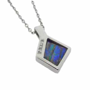 14K white gold pendant set with one natural boulder opal and accented with 5 princess cut diamonds totaling 0.083 carats, G-H, SI1-2.