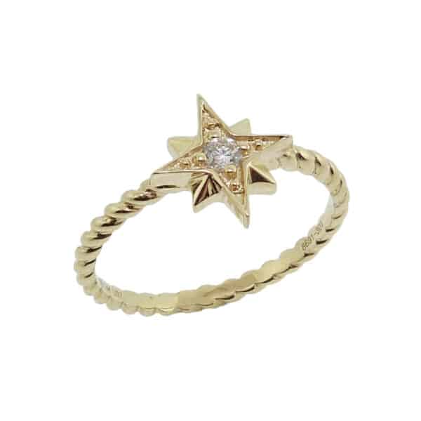 14K Yellow gold star emblem diamond lady's ring set with a 0.06cttw, I, SI1, very good cut round brilliant cut diamond.
