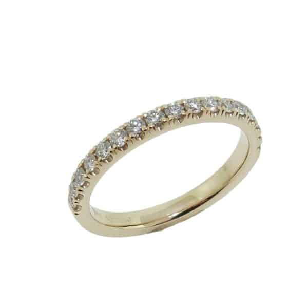 Lady's 14K yellow gold diamond band set with seventeen round brilliant cut diamonds totaling 0.36 carats, G-H, VS-SI, very good cut.