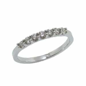 14K white gold diamond lady's band claw set with 7 J-K, SI, very good cut round brilliant cut diamonds, totaling 0.36 carats.
