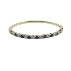 14K Yellow gold wired bracelet claw set with 12 round brilliant cut very good cut diamonds, J-K, SI1-2, totaling 2.05 carats, and 12 round blue sapphires, totaling 2.68 carats.