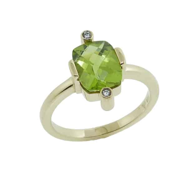 Lady's 14K yellow gold set with 1.94 carat checkboard peridot and accented with 2 round brilliant cut diamonds totaling 0.024 carats, H SI1-2, very good cut.