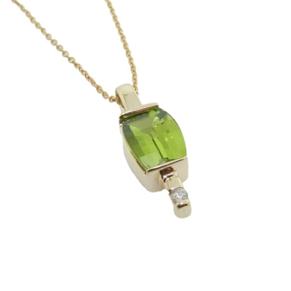 Lady's 14K yellow gold pendant set with a 2.23 carats checkboard peridot and accented with 0.03 carat H, I1, very good cut round brilliant cut diamond.