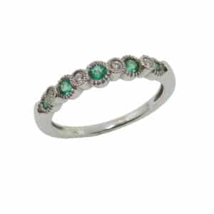 14K White gold lady's band set with 4 round brilliant cut diamonds, 0.05cttw, and 5 emeralds, 0.19cttw.