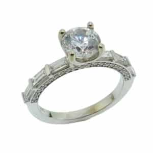 14K White gold engagement ring with profile details set with 1ct CZ, 6 baguette diamonds, 0.48cttw, and 42 round brilliant cut diamonds, 0.25cttw. Available in 14K gold, 18K gold, or platinum. This ring can be made in any combination of white, pink or yellow gold and can be customized to accommodate different size and shape diamonds, by special order. Priced without a center gemstone. Let us find you the perfect center that fits your tastes and budget!