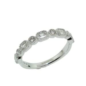 14K White gold lady's wedding band bezel set with 0.58cttw round brilliant cut and baguette diamonds. 