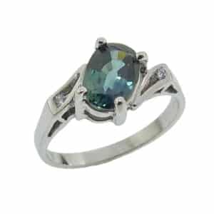 Lady's 14K white gold ring set with 1.34 carat oval blue/green sapphire accented with two round brilliant cut diamonds, totaling 0.015carat, G-H, SI1.