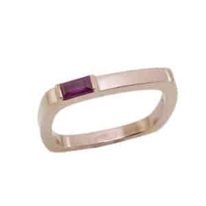 14K Rose gold square shank lady's band set with 0.15 carat ruby baguette.