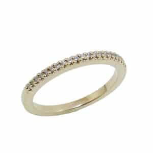 14K Yellow gold lady's diamond band claw set with 21 round brilliant cut diamonds, 0.11 total carat weight, G/H, VS-SI.