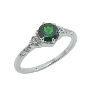 14K white gold ring set with 0.759 carat round Tsavorite and accented with 6 round brilliant cut diamonds totaling 0.09 carat, G-H, SI.
