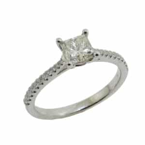 14K White gold engagement ring set with a 0.71 carat Princess cut diamond, K/L, I1 and with 22 claw set round brilliant cut diamonds on the band, 0.13 total carat weight, G/H, VS-SI. Special Sale price $1900 while it lasts, regular price is $4200.