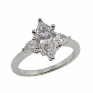 14K White gold three stone engagement ring set in the centre with a marquise shape lab grown diamond, 1.05 carat, E, VVS2 and accented on the sides with two pear shape lab grown diamonds, 0.314 total carat weight, F/G, VS2-SI1.