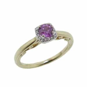 14K Yellow and white gold cushion shape halo engagement ring with a sculptural profile details on the shank set with one pink sapphire, 0.444 carat, and claw set in the halo 0.04 total carat weight, round brilliant cut diamonds, G/H, SI2.