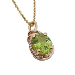 14K Rose gold pendant set with 1.38 carat peridot and accented with 8 round brilliant cut diamonds totaling 0.025 carats, H, SI1-2.