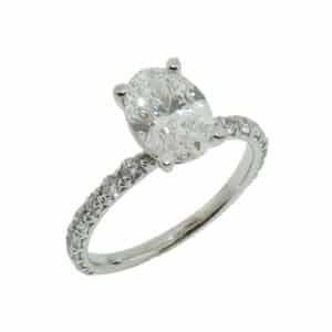 14K White gold diamond engagement ring set with one 1.37 carat, D, VVS2 oval lab grown diamond claw set on the sides with 16 round brilliant cut lab grown diamonds totaling 0.48 carats, VS, E/F.