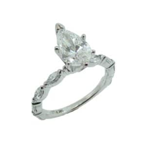 14K White gold engagement ring set with one pear shape lab grown diamond, 1.06 carat, D, VS1. Accented on the sides with 8 marquis shaped lab grown diamonds totaling 0.64 carats, VS, E/F.
