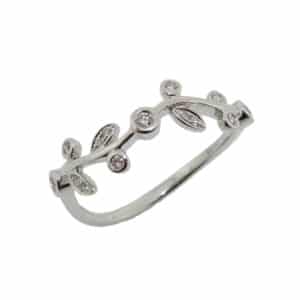 14K White gold lady's band set with fifteen round brilliant cut diamonds, 0.10 total carat weight.