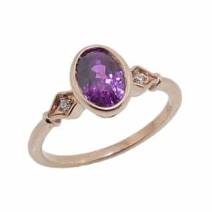 14K Rose gold lady's ring bezel set in the centre with a 1.74 carat untreated purple sapphire and accented on the band with 2 round brilliant cut diamonds, 0.02 total carat weight, G/H, SI.