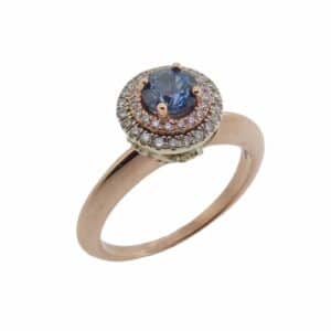 14K White and rose gold ring set with one 0.60 carat round Montana blue sapphire claw set on the double halo and in the gallery with 46 round brilliant cut diamonds totaling 0.20 carats, SI2, H/I.