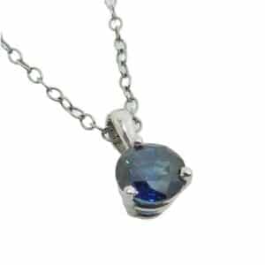 14K White gold pendant set with one 0.569 carat round blue sapphire.