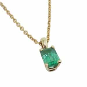 14K Yellow gold pendant set with one 0.446 carat emerald cut emerald.