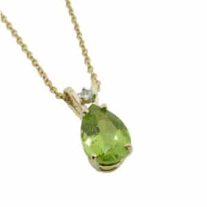 14K Yellow gold pendant set with a 1.37 carat pear shape Peridot and accented with a 0.02 carat round brilliant cut diamond.