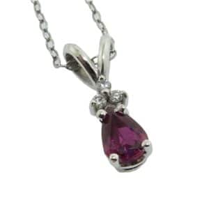 14K White gold pendant set with a 0.364 carat pear shape Ruby and three, round brilliant cut diamonds, 0.028cttw.