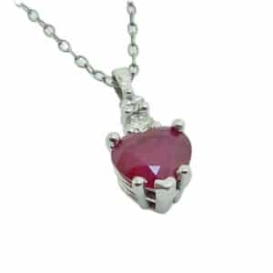 14K White pendant set with 1.04 carat heart shape ruby and 2 round brilliant cut diamonds, 0.09 total carat weight, SI.