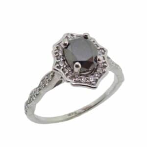 14K White gold vintage style halo set in the centre with a 1.48 carat oval black diamond and in the halo and on the band with 38 natural round brilliant cut diamonds, 0.24 total carat weight, G/H, SI1-2. 