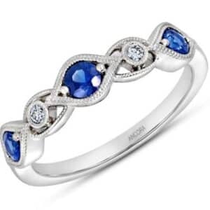 14K White gold lady's band set with two round brilliant cut diamonds, 0.05 total carat weight, alternating with three round sapphires, 0.48 total carat weight.