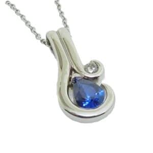 14K White gold custom pendant set with a 1.01 carat pear shaped blue sapphire and accented with 0.082 carat natural round brilliant cut diamond, G-H, SI1.