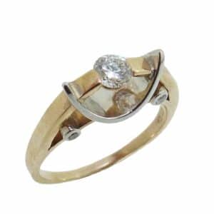 14K White and yellow gold lady's ring channel set in the center with a very good cut, round brilliant cut diamond, 0.27 carat, G-H, SI2. Accented in the profile with four round brilliant cut diamonds, totaling 0.08 carats, G-H, SI.