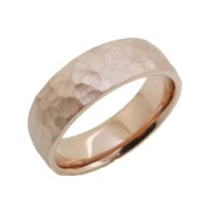 14K Rose gold 7mm wide domed men's band with a hammered texture and a stainless finish. Available in 14K gold, 18K gold, or platinum. This ring can be made in any combination of white, pink or yellow gold and can be customized to different widths and finishes by special order.
