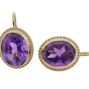 14K Yellow gold lever back earrings bezel-set with two 10X8 mm oval amethyst.