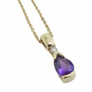 14K Yellow gold pendant set with one 7x5mm pear-shaped amethyst and one 0.04 carat round brilliant cut diamond, G/H, SI