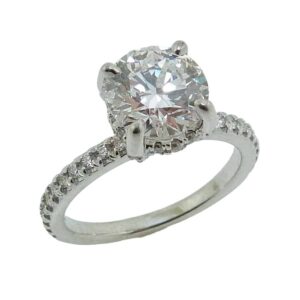14K White gold hidden halo solitaire engagement ring claw set in the centre with a 1.55 carat, D, VVS2, round brilliant cut, lab grown diamond. Accented on the band and in the hidden halo with 0.303 total carat weight, F/G, VS, natural round brilliant cut diamonds.