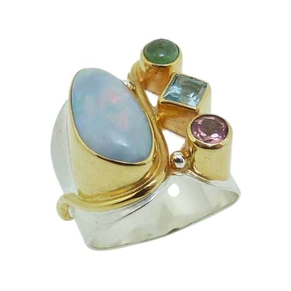 Sterling silver ring bezel set with kyanite, opal, pink tourmaline, and topaz and is accented with 22 karat yellow gold vermeil.
