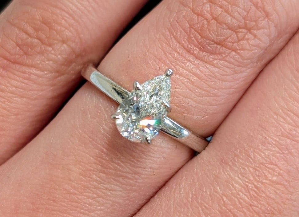 A pear shaped diamond set in an engagement ring.