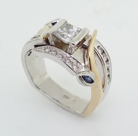 A custom engagement ring set with a princess shaped diamond. Princess shaped diamonds are no longer as popular as they were.