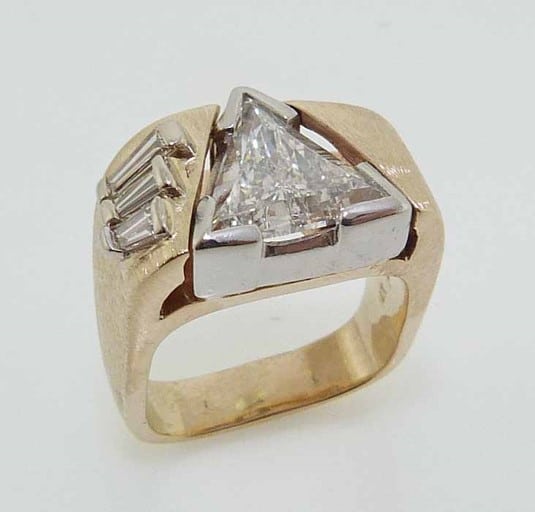 A modern custom engagement ring set with a trillion shaped diamond.