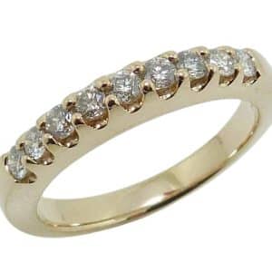 14K Yellow gold lady's wedding band claw set with nine round brilliant cut natural diamonds totaling 0.226 carats, G-H, VS-SI.