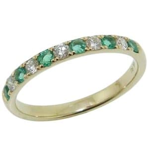 14K Yellow gold emerald and diamond lady's band claw set with five round brilliant cut diamonds, 0.17 total carat weight, and six emeralds, 0.21 total carat weight.