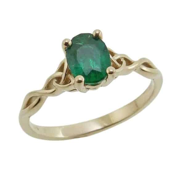 14K Yellow gold lady's Celtic knot ring claw set with a 0.779 carat emerald.