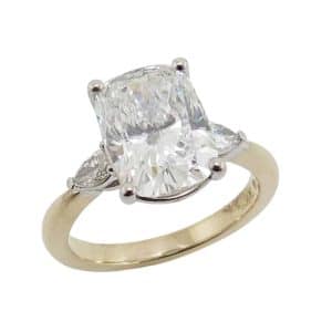14K Yellow and white gold three stone engagement ring claw set with a 3.00 carat, D, VVS2 cushion modified brilliant cut lab grown diamond and pear brilliant cut lab grown diamonds, 0.19 total carat weight, F/G, VS.
