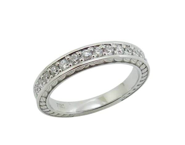 Platinum engraved lady's wedding band pave set with thirteen natural round brilliant cut diamonds, 0.274 total carat weight, E/F, VS+.