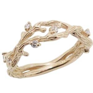 14K Yellow gold textured open twist lady's band claw set with eight very good cut, natural round brilliant cut diamonds, 0.13 total carat weight, H/I, SI.
