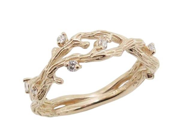 14K Yellow gold textured open twist lady's band claw set with eight very good cut, natural round brilliant cut diamonds, 0.13 total carat weight, H/I, SI.