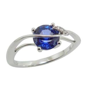 14K White gold Chatham lady's ring set with a 1.5 carat Chatham blue sapphire and accented with 0.02 total carat weight mined round brilliant cut diamonds.
