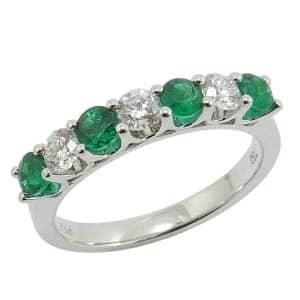 18K White gold lady's band claw set with four emeralds, 0.46 total carat weight, and three round brilliant cut diamonds, 0.35 total carat weight, G/H, SI.